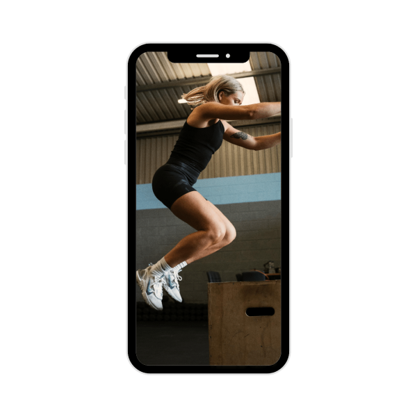 iPhone with photo inside of Anita doing box jumps in the Gym