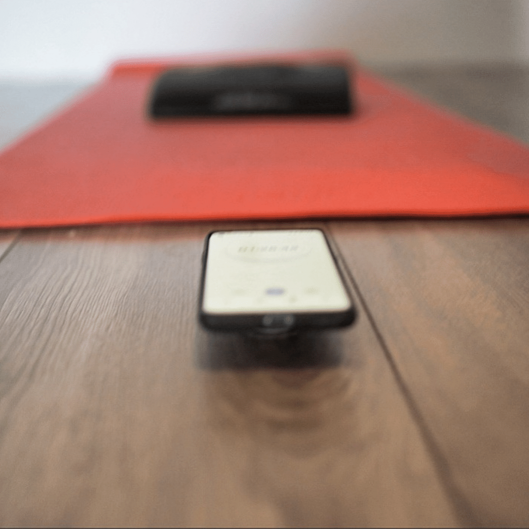 Orange Yoga mat with phone with a timer on infront of mat
