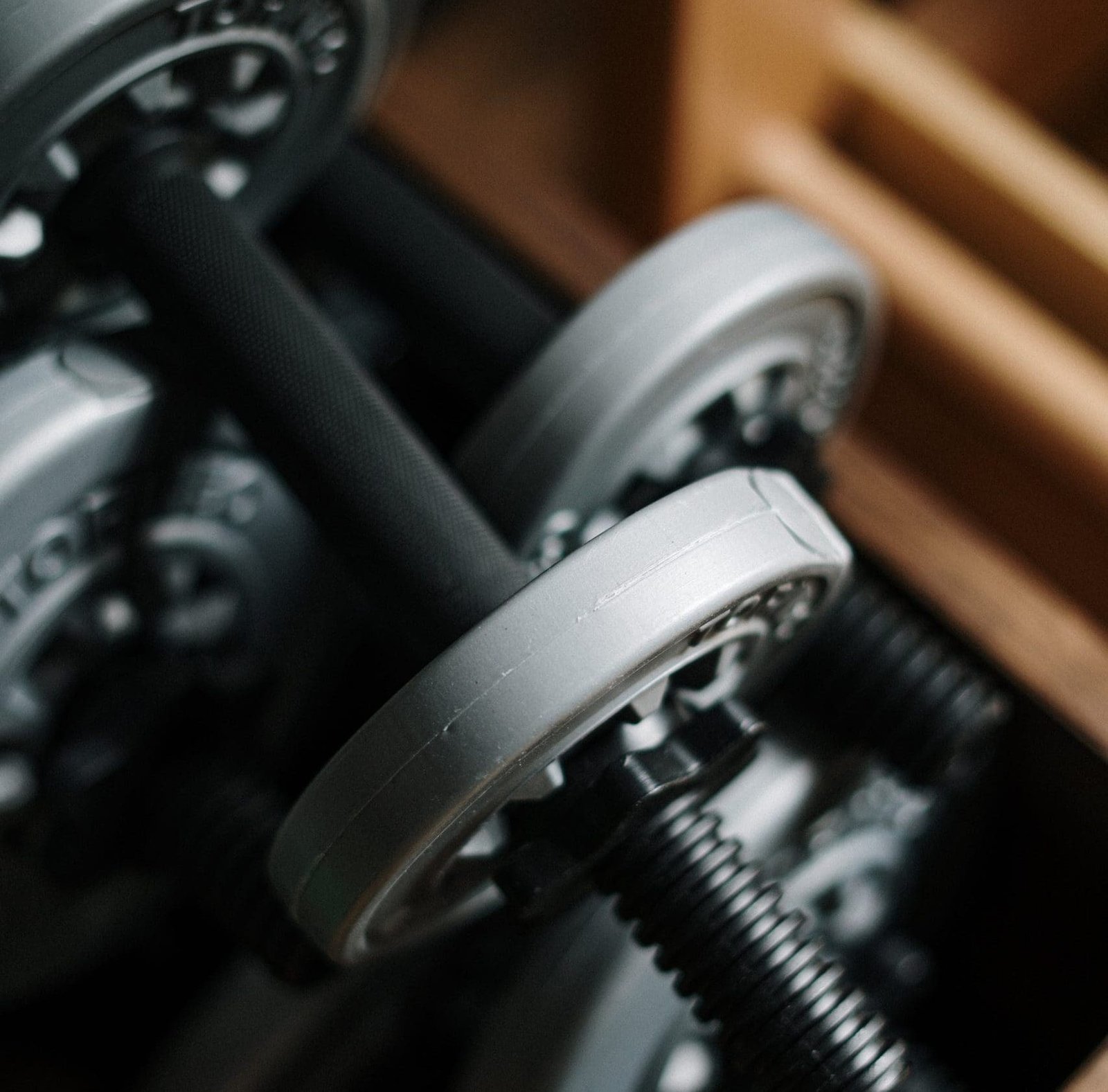 Image of Dumbbells stacked up with brown background