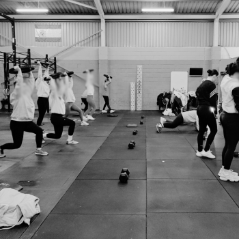 Team Workout- Ladies pictured in the gym with weights overhead & doing burpees