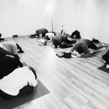 Clients pictured in a stretch class where all are on yoga mat with yoga blocks eitherside